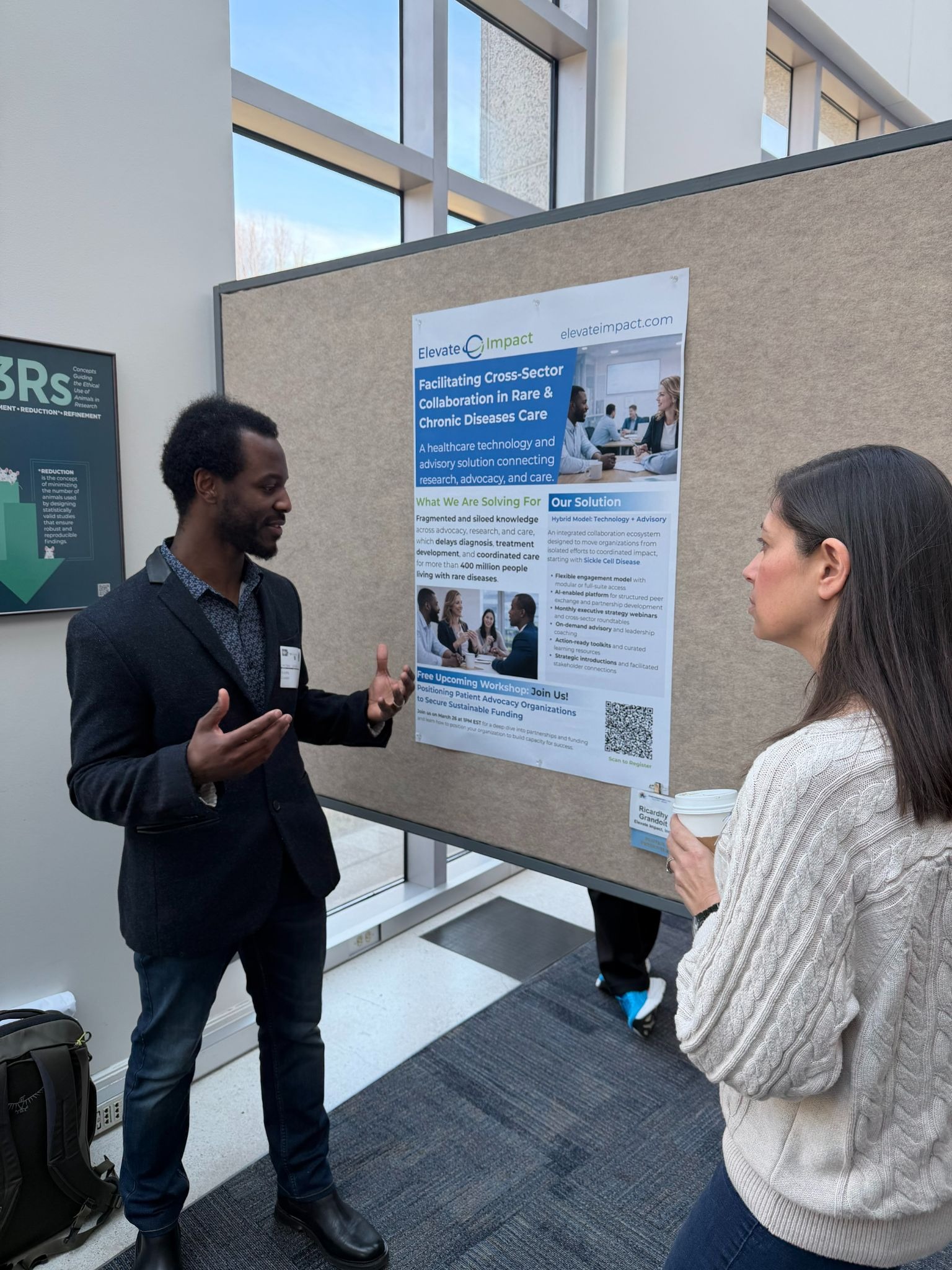 Elevate Impact team member presenting a cross-sector collaboration poster to a conference attendee